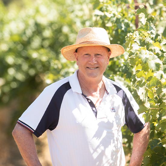 Mark Lyon standing in the Eco Terreno biodynamic vineyard