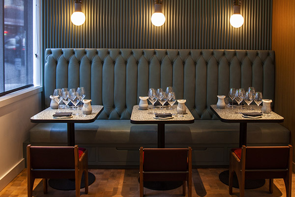 Olive green banquette in the urban tasting room